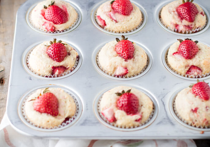 Soft and tender, playful and joyful, quick and easy strawberry coconut muffins. The perfect way to start your day or enjoy all day long. Light on sugar, filled with a delicious combination of sweet strawberries and shredded coconut! 