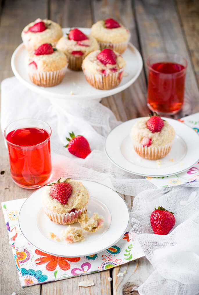 Soft and tender, playful and joyful, quick and easy strawberry coconut muffins. The perfect way to start your day or enjoy all day long. Light on sugar, filled with a delicious combination of sweet strawberries and shredded coconut!