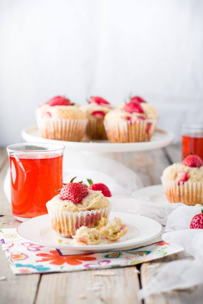 Soft and tender, playful and joyful, quick and easy strawberry coconut muffins. The perfect way to start your day or enjoy all day long. Light on sugar, filled with a delicious combination of sweet strawberries and shredded coconut!