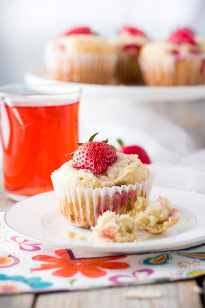 Soft and tender, playful and joyful, quick and easy strawberry coconut muffins. The perfect way to start your day or enjoy all day long. Light on sugar, filled with a delicious combination of sweet strawberries and shredded coconut!