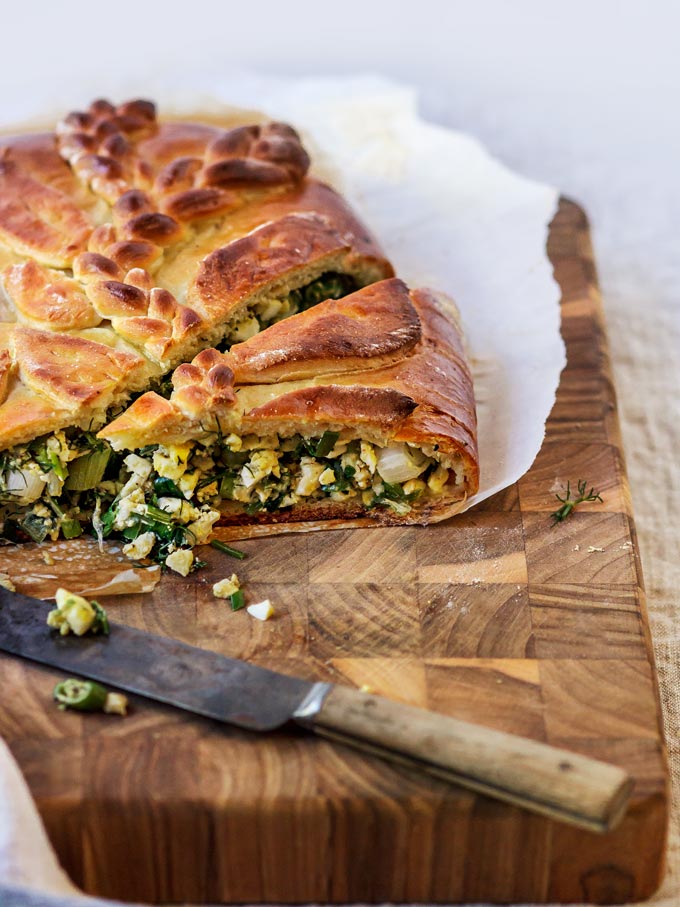 This Ukrainian savory egg and fresh herbs pie is a family recipe and one of my favorite pies from the childhood. The combination of fresh eggs from a local farm and fragrant seasonal dill, parsley and scallions wrapped in a soft, lightly sweetened yeasted dough will make you fall in love with this recipe.