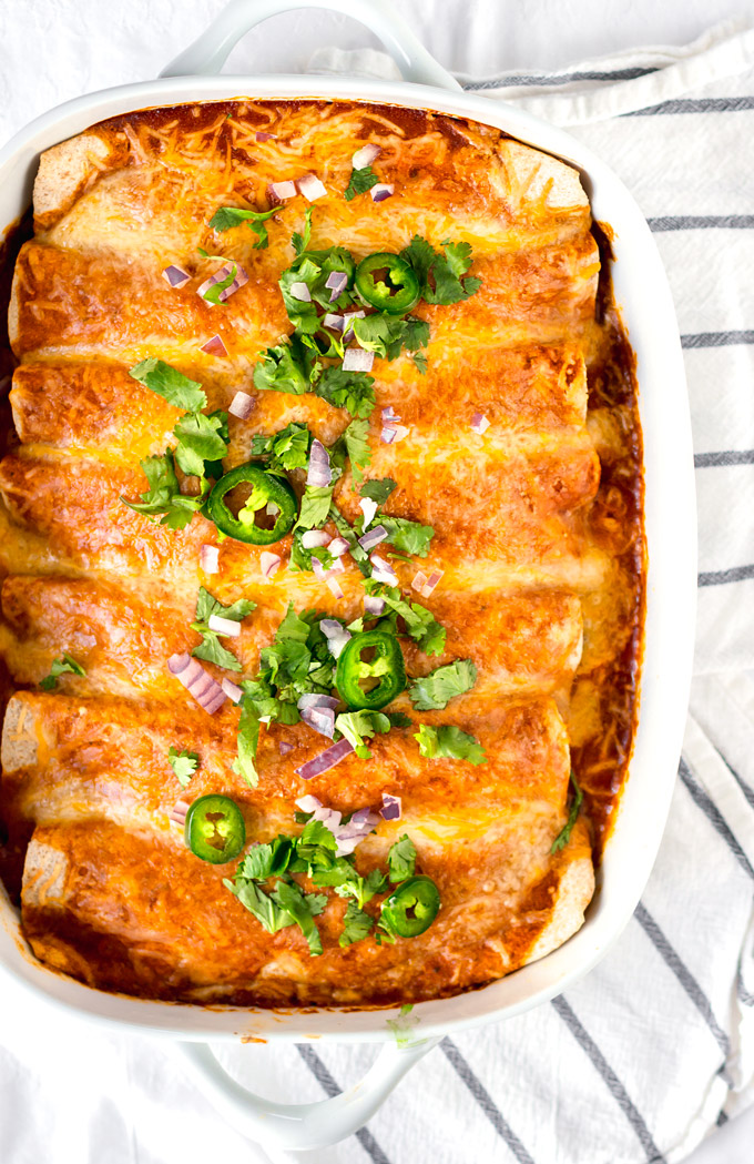 Easy and Healthy Rotisserie chicken enchiladas recipe with a simple homemade enchilada sauce. A quick and healthy alternative to takeout, and a good way to use cooked leftover chicken. This recipe is a part of my 5 Easy Recipes with leftover rotisserie chicken project. #chicken #rotisserie #rotisseriechickenrecipe #enchiladas #enchilada sauce #healthy #easy