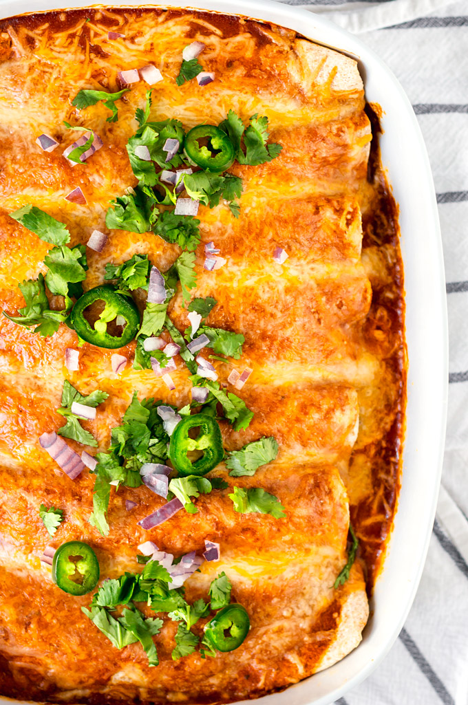 Easy and Healthy Rotisserie chicken enchiladas recipe with a simple homemade enchilada sauce. A quick and healthy alternative to takeout, and a good way to use cooked leftover chicken. This recipe is a part of my 5 Easy Recipes with leftover rotisserie chicken project. #chicken #rotisserie #rotisseriechickenrecipe #enchiladas #enchilada sauce #healthy #easy
