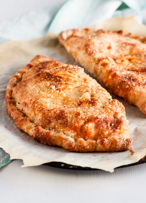 This buffalo rotisserie chicken calzone recipe is a part of my 5 Easy Recipes with leftover rotisserie chicken project. It is easy to make, fast to put together and a fun dinner to enjoy on the weekends or when you crave for some not so healthy food. You will also learn a lot of Tips and Tricks on how to make a perfect calzone with any filling in the comfort of your home. #calzone #buffalosauce #rotisseriechicken #chicken