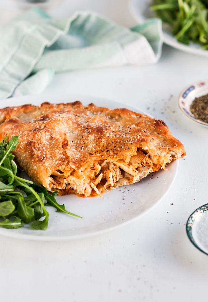 This buffalo rotisserie chicken calzone recipe is a part of my 5 Easy Recipes with leftover rotisserie chicken project. It is easy to make, fast to put together and a fun dinner to enjoy on the weekends or when you crave for some not so healthy food. You will also learn a lot of Tips and Tricks on how to make a perfect calzone with any filling in the comfort of your home. #calzone #buffalosauce #rotisseriechicken #chicken