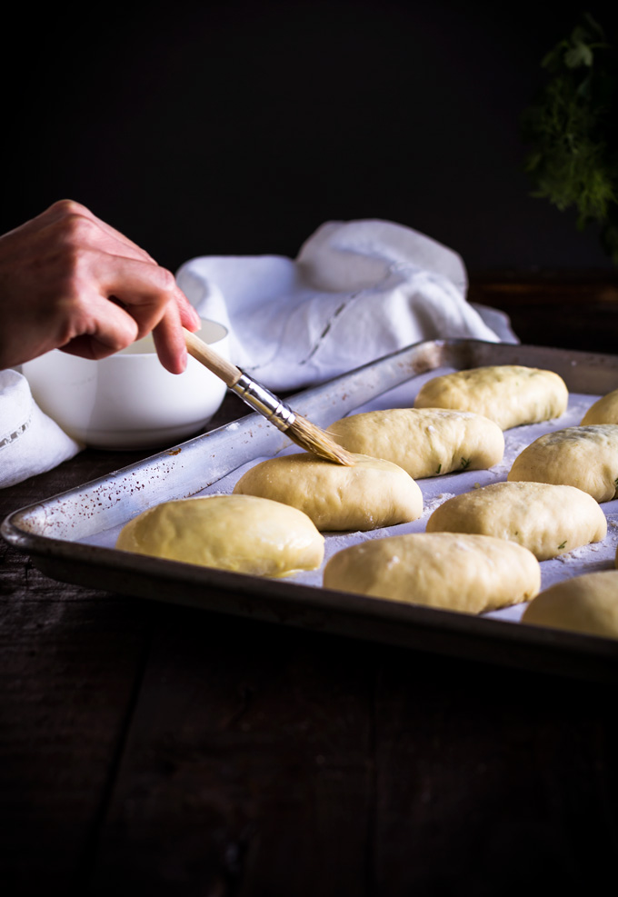 In this post, you will learn how to make authentic Ukrainian piroshki recipe. In English- fresh herbs, egg and rice vegetarian hand pies. Piroshki, pirozhki, pyrizhky are both sweet and savory hand pies made from yeasted dough and are an essential part of the Ukrainian and Russian cuisine. This is the family best piroshki recipe, and I’m very excited to share it with you. And as always in the post, I share some tips and tricks on how to make piroshki from scratch. #piroshki #handpies #savoryhandpies