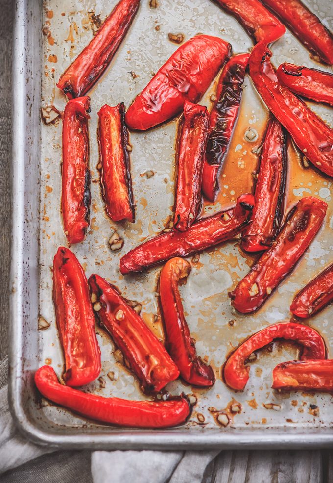 In this recipe, you will learn how to make oven roasted peppers. Oven roasted bell peppers are super easy to make, very delicious and so versatile. Make one batch of homemade roasted red peppers and use it different dishes or eat it straight from a jar! #roastedpeppers #bellpeppers