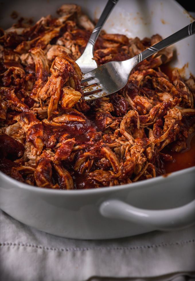 In this post, you will learn how to make BBQ chicken 2 ways: instant pot pulled bbq chicken, and stovetop pulled bbq chicken breast recipe. Both ways yield the fragrant, juicy barbeque chicken that you can shred and enjoy the way you like it. And there are so many ways to use leftover bbq chicken. So many dinner ideas and inspiration. Plus the easy two-step process makes it a time saver dinner! #bbqchicken #pulledchicken #chicken #bbq