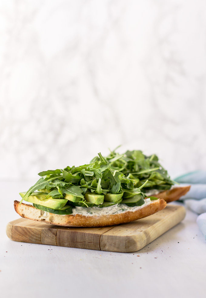 Beautiful and delicious vegetarian cucumber and avocado sandwich recipe. In about 15 minutes you have a healthy vegetarian sandwich full of flavors and vitamins to enjoy any time of the day. Even though it is a veggie sandwich, it will keep you full and satisfied for many hours. Grab this green goddess sandwich recipe and make it for breakfast, lunch or even dinner. Enjoy ;) #sandwich #vegetarian #veggierecipe #avocado