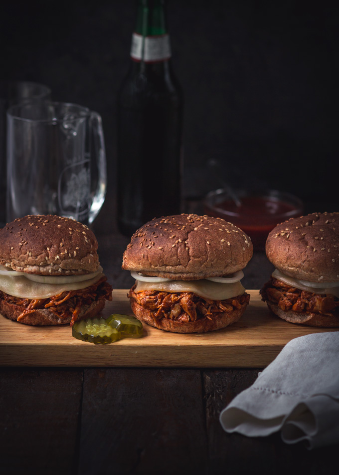 Amazing bbq chicken sliders recipe. These pulled chicken sliders consist of two parts: the homemade BBQ sauce and bbq shredded chicken. Both recipes included. Soft slightly toasted whole wheat buns. Creamy, chewy cheese. And a thinly sliced onion. All of these layers combined create the best chicken sliders. Instant pot chicken sliders are a delicious and easy way to feed a crowd! Or a great finger food dinner to enjoy with friends and family. #bbq #chicken #sliders #burger