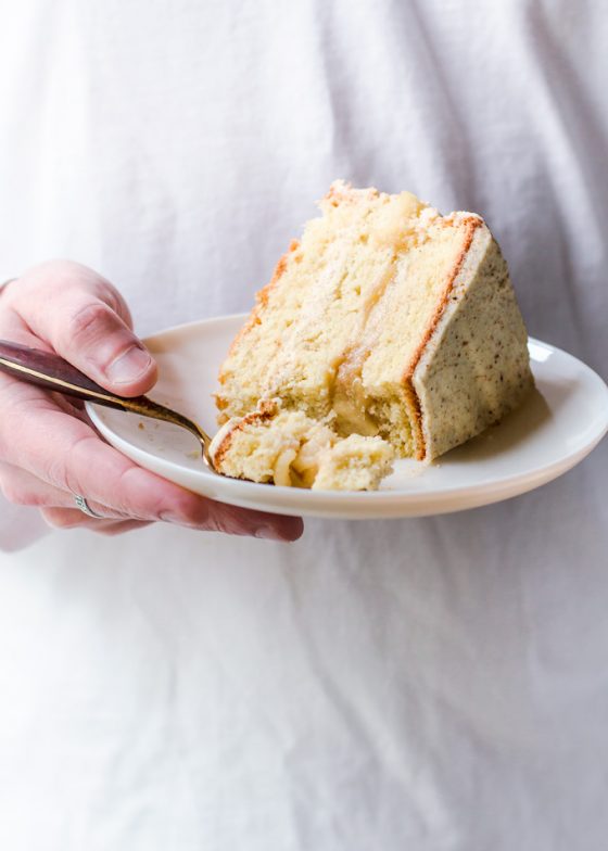 This lighter apple layer cake with whiskey almond frosting is a true fall celebration. It is made with layers of light and airy genoise (sponge) cake with light whiskey scented cream in between and an aromatic apple filling! This can be a Thanksgiving apple layer cake, a special occasion layer cake or a cake to celebrate the most flavorful season – autumn. One thing for sure – this apple and almond layer cake steals the show! Truly the best apple layer cake! #cake #apples #apple #dessert #layercake