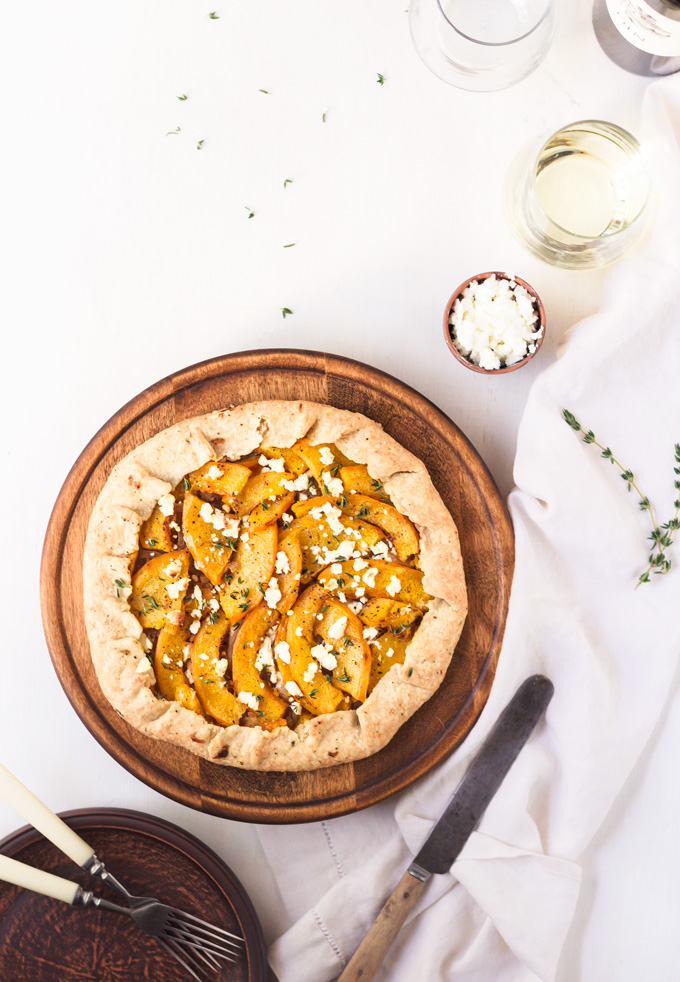 This savory pumpkin galette with flaky parmesan pie crust is a staple fall recipe in my kitchen. The flaky parmesan crust infused with fresh thyme leaves. The creamy sauteed onions in white wine. The sweat and savory pumpkin slices. And freshly crumbled goad cheese. All these layers create flavorful, savory pumpkin pie. An incredibly delicious, flavorful and beautiful fall galette. If you are searching for the pumpkin dinner recipe, then look no more! #pumpkin #galette #pumpkingrecipe